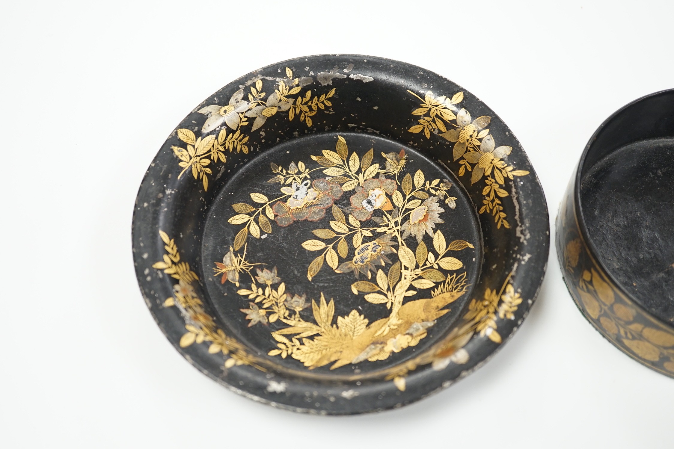 A Regency toleware coaster and a similar papier maché coaster, largest 16cm diameter